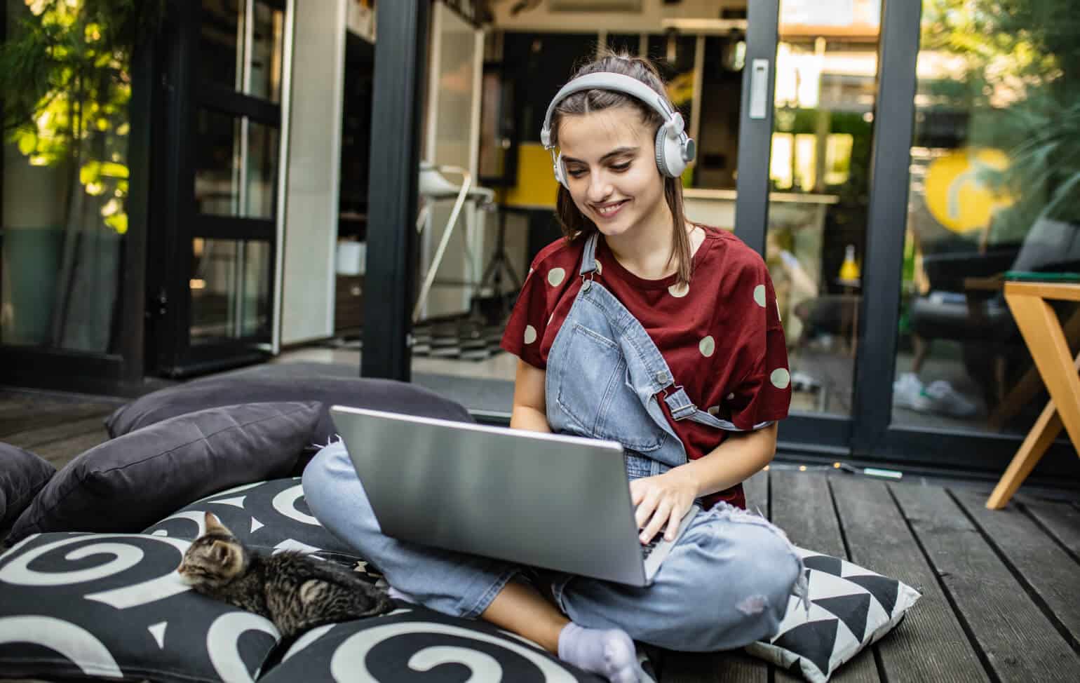 High school student working outside with pet kitten
