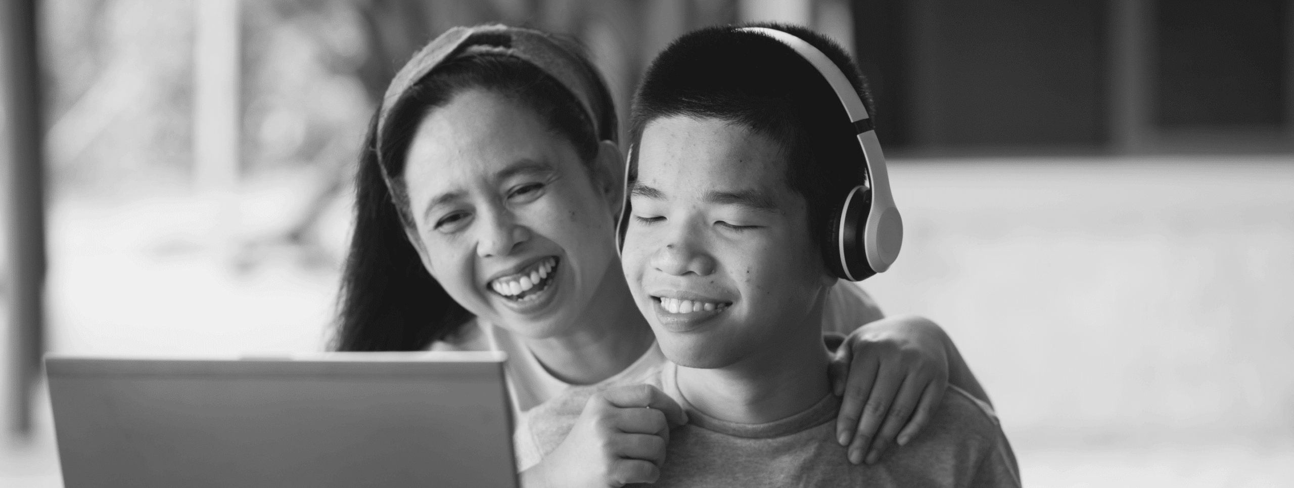 Mother and student seeking student services on laptop